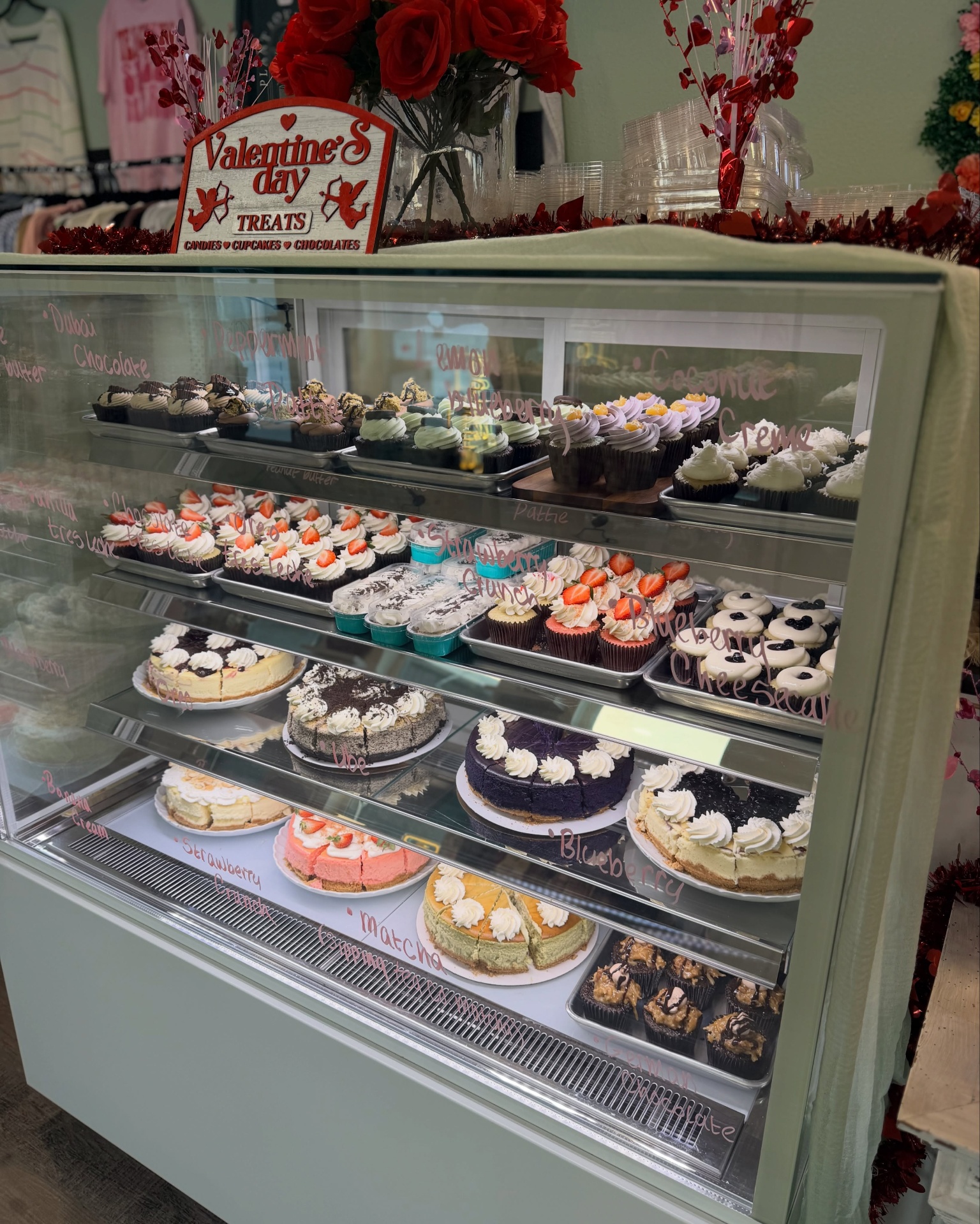 Aurora Bakery Valentine's display case with cupcakes and cheesecakes
